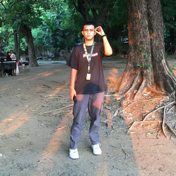 Ashley standing under a tree